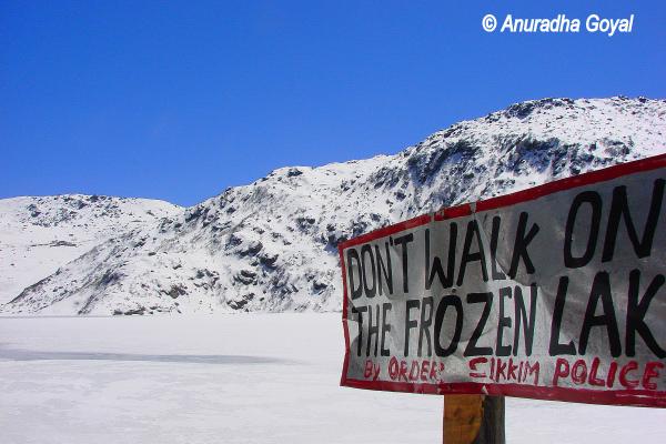 Warning board not to walk on the Frozen Tsomgo lake