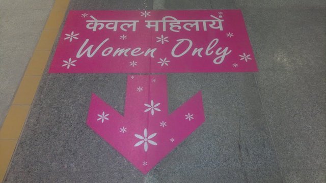 Pink sign guiding towards Delhi Metro's Women Only Coach