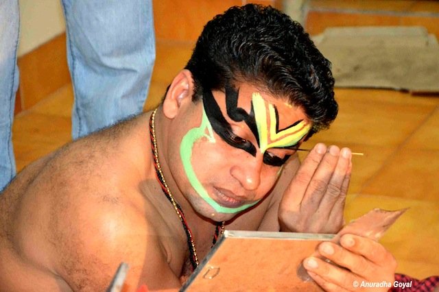 Facial makeup in progress for the Kathakali perfomer