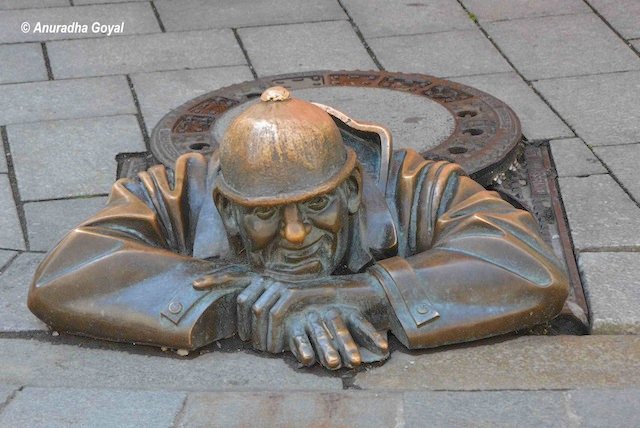 Sculpture of a man standing in drainage at Bratislava