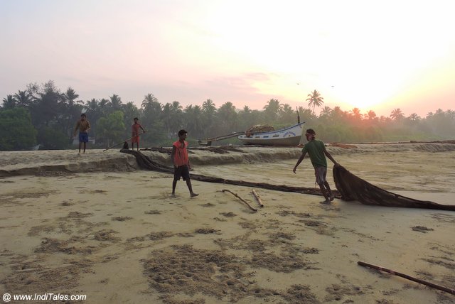 Traditional Fishermen rolling their fishing nets early in the morning