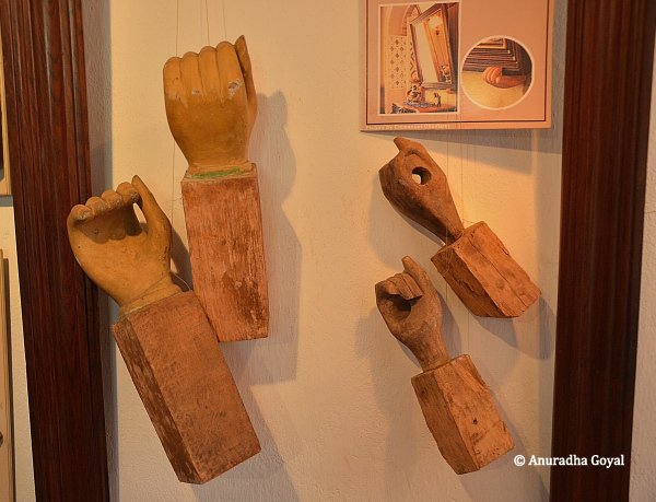 Wooden frames in the shape of hands to hold paintings