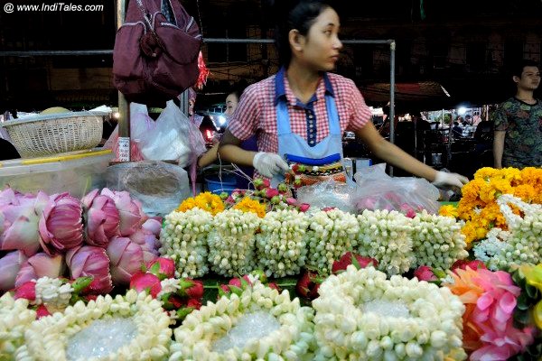 A woman selling arranged flowers at Bangkok Flower Market 