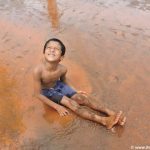 a little boy in mud at chikal kalo festival, Goa