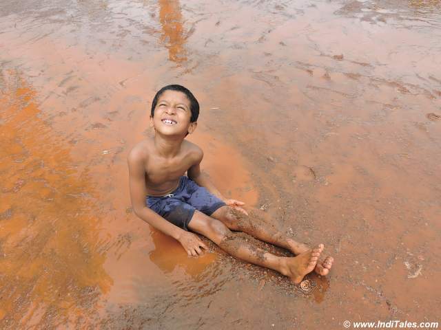 a little boy in mud at chikal kalo festival, Goa