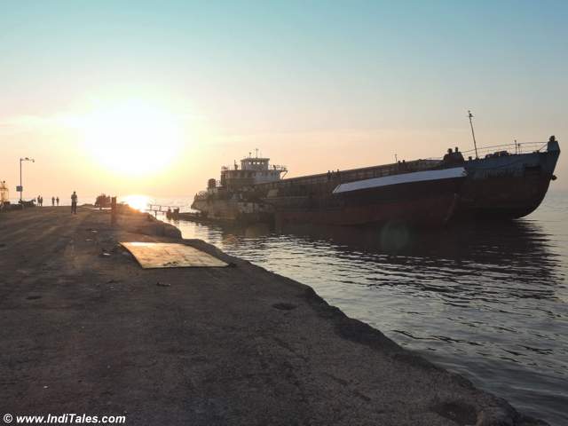 A cargo barge at the Jetty during high tide and the Sunrise