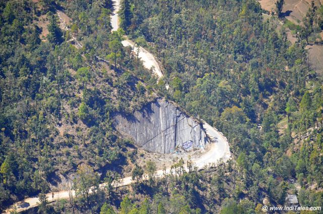 A road in the valley passing by steep rock