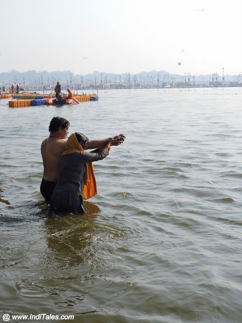 Devotees taking a holy dip at Triveni Sangam