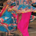 Traditionally dressed performers of Garba songs dance