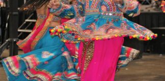 Traditionally dressed performers of Garba songs dance